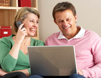 Home equity image of couple in front of computer